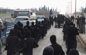 Fighters of al-Qaeda linked Islamic State of Iraq and the Levant parade at the Syrian town of Tel Abyad, near the border with Turkey January 2, 2014. REUTERS/Yaser Al-Khodor