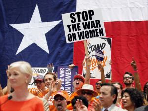 Image: Protesters hold signs and cheer during a protest before the start of a special session of the Legislature in Austin, Texas