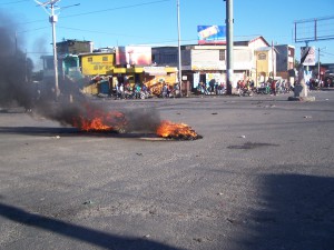 On Feb. 2, a national transport strike left streets around Haiti empty, with occasional protest pyres of burning tires. This scene is from Port-au-Prince. Credit: Daniel Tercier/Haïti Liberté 