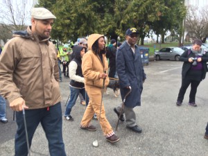 Jesse Hagopian (left in white cap) at golf club march; Mr. Wingate on the right