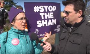 Pro-choice-abortion-supporter-at-rally-with-Stop-the-Sham-sign
