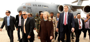 U.S. Secretary of State Hillary Rodham Clinton walks from her C-17 military transport upon her arrival in Tripoli Libya, Tuesday Oct. 18, 2011. The Obama administration on Tuesday increased U.S. support for Libya's new leaders as Secretary of State Hillary Rodham Clinton made an unannounced visit to Tripoli and pledged millions of dollars in new aid, including medical care for wounded fighters and additional assistance to secure weaponry that many fear could fall into the hands of terrorists. (AP Photo/Kevin Lamarque, Pool)