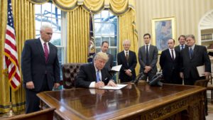 A gang of reactionary men stand by as Trump signs an executive order reinstating the Mexico City Policy. 