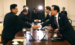 South Korean Vice Unification Minister Chun Hae-sung, second from right, shakes hands with the head of North Korea's delegation Jon Jong Su, second from left, after their meeting on January 17 in Panmunjom, South Korea.