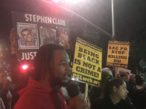 Cousin of Stephon Clark gives speech in front of Meadowview Light Rail station during Friday vigil. Liberation photo.