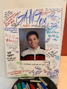 portrait of 15 year old Jayson Negron, murdered by Bridgeport police in 2017, framed by signed notes from the community