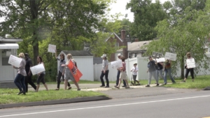 Activists march down Jordan Lane in Connecticut to protest police violence and the murder of Anthony "Chulo" Jose Vega Cruz. 