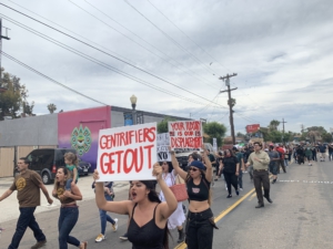 People march through the streets of Barrio Logan. Liberation photo. 