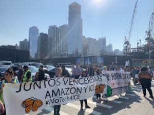 Amazon workers on strike march with a large banner. 