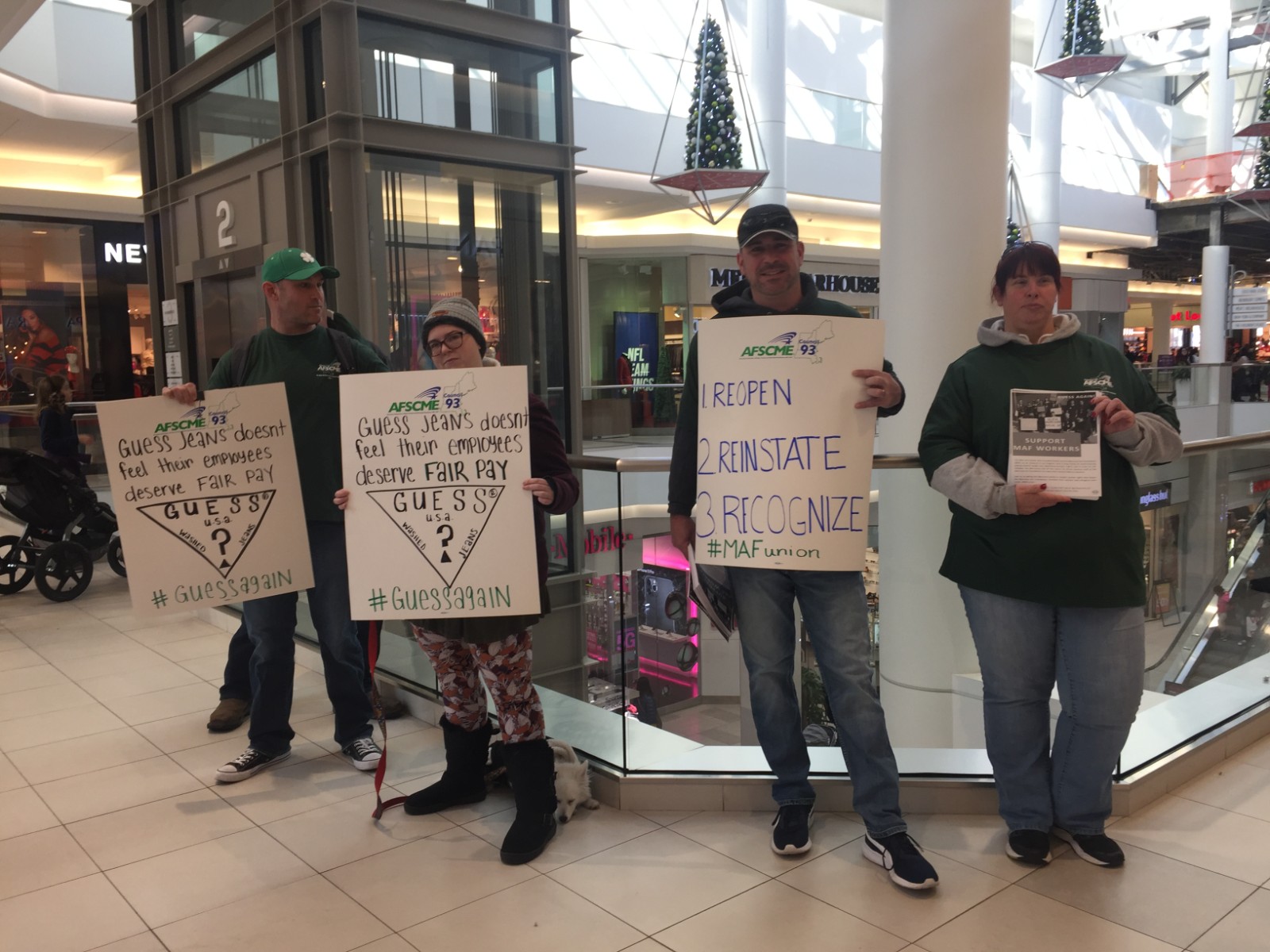 Peaceful protesters outside GUESS in the CambrdigeSide Galleria, Cambridge, Massachusetts.