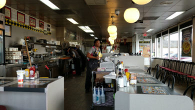 A Waffle House employee gazes over an empty counter. Photo: Whaledad / CC BY-SA (https://creativecommons.org/licenses/by-sa/4.0)