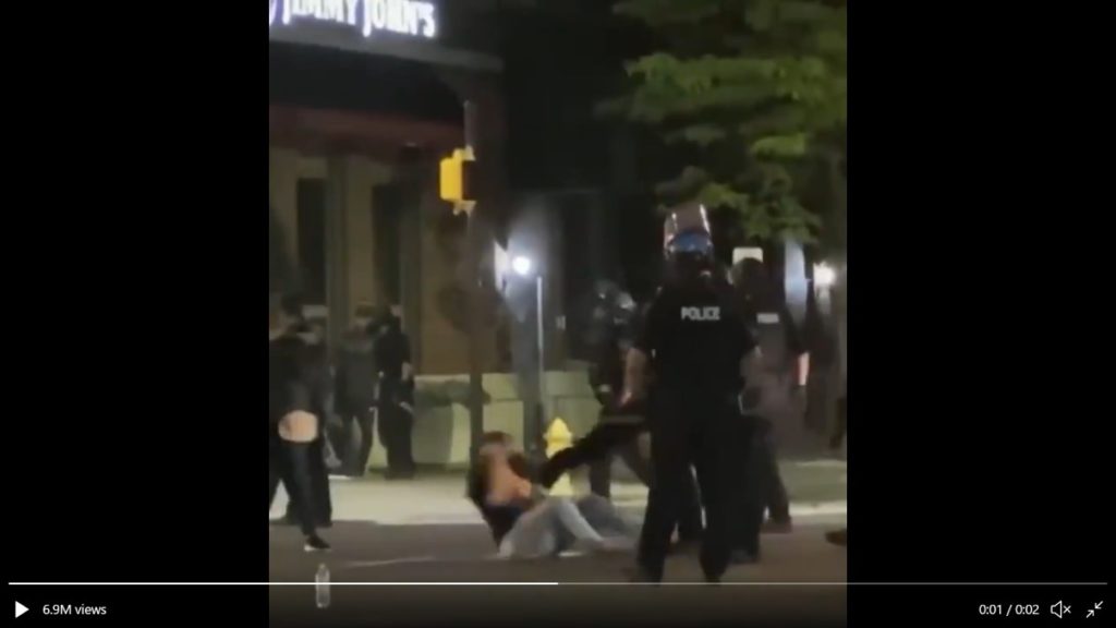 Liberation screen grab from video of police kicking Hannah Silbaugh. 