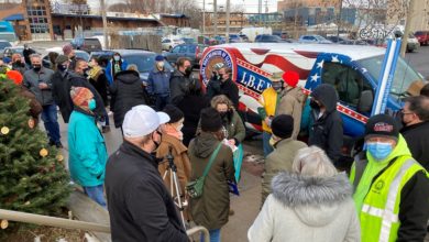 Colectivo workers and supporters rally before delivering a petition to the company demanding that it stop delaying IBEW union certification. Liberation photo