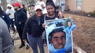 Family members hold Keishon Thomas' picture at a vigil and balloon release on Feb. 28. Liberation photo