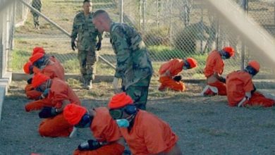 Detainees upon arrival at Camp X-Ray, Guantánamo Bay, January 2002. Photo credit: Shane T. McCoy, U.S. Navy. Public domain image.
